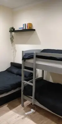 a room with two bunk beds and a shelf at LFC Stadium Apartment 1 in Liverpool