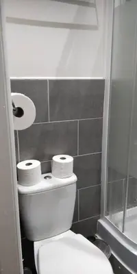 a bathroom with a toilet with two rolls of toilet paper at LFC Stadium Apartment 1 in Liverpool