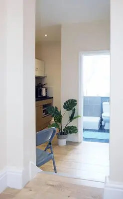 a kitchen with a plant and a chair in a room at LFC Stadium Apartment 2 in Liverpool