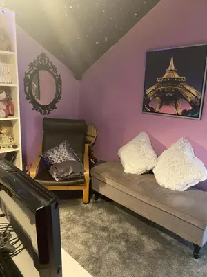 a living room with a couch and a mirror at Tuebrook Towers in Liverpool