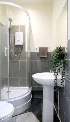 a bathroom with a sink and a toilet and a shower at LFC Stadium Apartment 3 in Liverpool