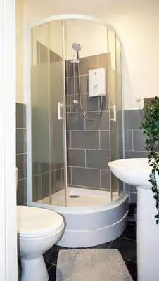 a bathroom with a shower and a toilet and a sink at LFC Stadium Apartment 3 in Liverpool