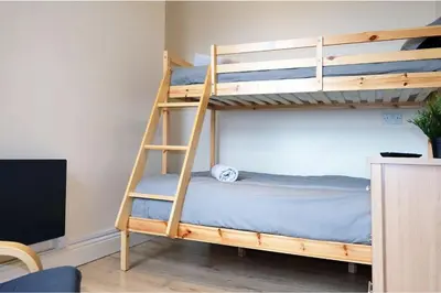 a bedroom with two bunk beds and a television at LFC Stadium Apartment 4 in Liverpool