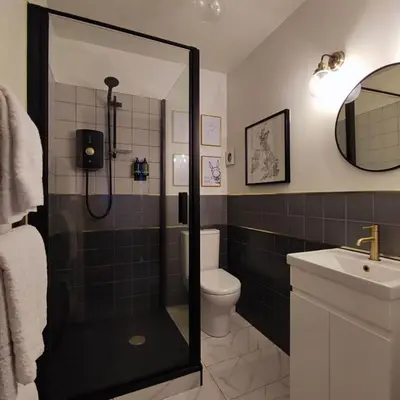a bathroom with a shower and a toilet and a sink at Merchant House in Bootle