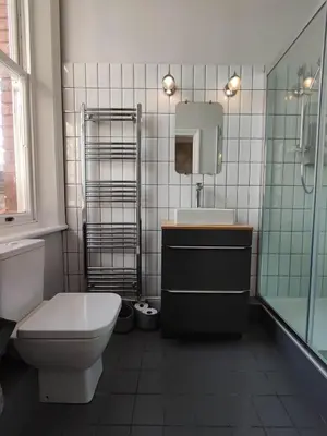 a bathroom with a toilet and a sink and a mirror at Merchant House in Bootle