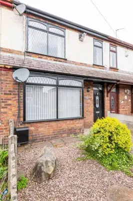 a brick house with a rock in front of it at Memory Lane - beautifully renovated house close to motorway networks in Shevington
