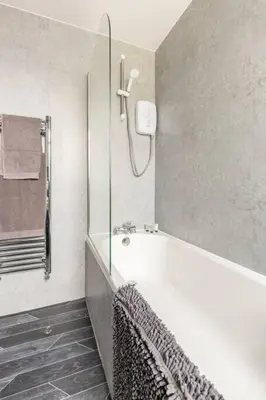 a bathroom with a shower and a bath tub at Memory Lane - beautifully renovated house close to motorway networks in Shevington