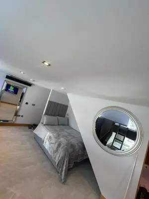 a bedroom with a bed and a round mirror at Belvedere Aparthotel - 83 Mount Pleasant in Liverpool