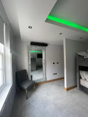 a room with a mirror and a chair in a room at Belvedere Aparthotel - 83 Mount Pleasant in Liverpool