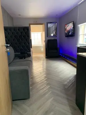 a living room with a couch and a tv at Belvedere Aparthotel - 83 Mount Pleasant in Liverpool