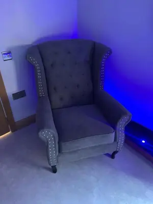a blue chair in a room with a purple wall at Belvedere Aparthotel - 83 Mount Pleasant in Liverpool
