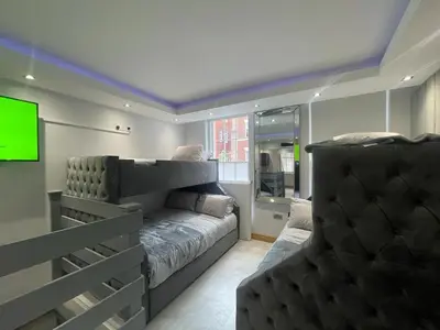 a living room with a couch and a tv at Belvedere Aparthotel - 83 Mount Pleasant in Liverpool