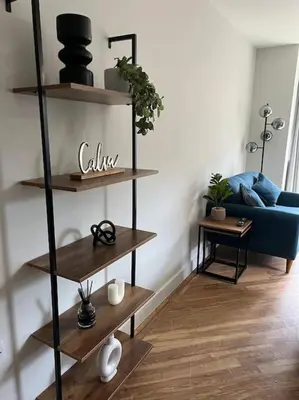 a living room with a blue couch and wooden shelves at The 9th Hole - Two-Bedroom Apartment in Birkdale, 1 mile from Royal Birkdale Golf Club in Southport