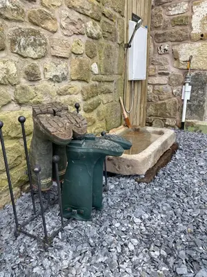 a stone building with a sink and a tub at New purpose built holiday lodge in Scorton