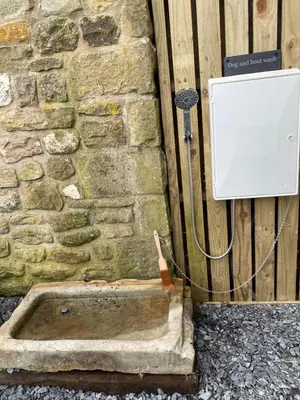 a box on the side of a brick wall at New purpose built holiday lodge in Scorton