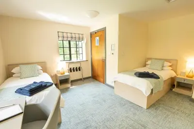 a bedroom with two beds and a window at Theodore House in Clitheroe
