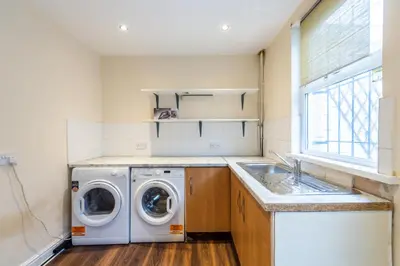 a laundry room with a washing machine and a sink at 10 Guests - Free Parking - City Centre in Liverpool