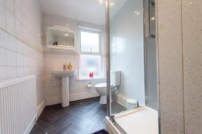 a bathroom with a toilet and a sink and a shower at 10 Guests - Free Parking - City Centre in Liverpool