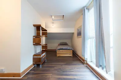 a hallway with a bed and a window at 10 Guests - Free Parking - City Centre in Liverpool