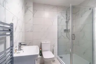 a bathroom with a shower and a toilet and a sink at Modern 1 Bedroom Apartment in Liverpool in Liverpool
