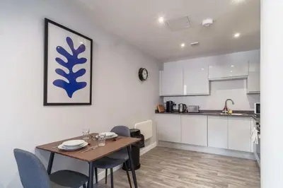 a kitchen and dining room with a table and chairs at Modern 1 Bedroom Apartment in Liverpool in Liverpool