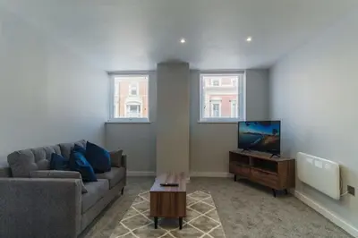 a living room with a couch and a flat screen tv at Modern 1 Bedroom Apartment in Liverpool in Liverpool