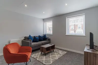 a living room with a couch and a television at Modern Convenient 2 Bedroom Apartment in Liverpool in Liverpool