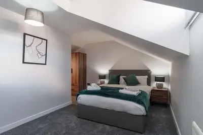 a bedroom with a king sized bed in a attic at Stunning 2 Bedroom Apartment in Liverpool in Liverpool