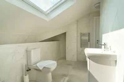 a white bathroom with a toilet and a sink at Stunning 2 Bedroom Apartment in Liverpool in Liverpool