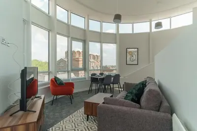 a living room with a couch and a table at Stunning 2 Bedroom Apartment in Liverpool in Liverpool