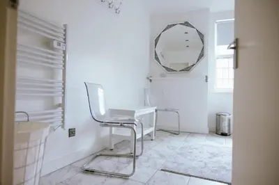 a white room with a desk and a mirror at COZY PLACE LIVERPOOL in Liverpool
