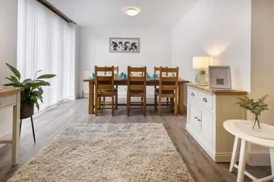 a dining room with a table and chairs at Manor Farm Barn Cottage in Burton
