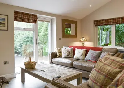 a living room with a couch and a coffee table at Blenkett Wood Lodge Park in Kents Bank