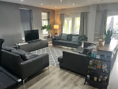 a living room with couches and a flat screen tv at Spacious 2 Bed Ribble Valley Apartments in Blackburn