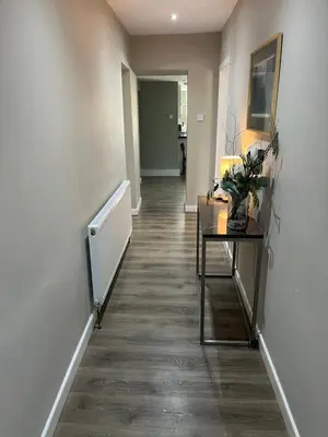 an empty hallway with a table and a hallway with a hallway at Spacious 2 Bed Ribble Valley Apartments in Blackburn