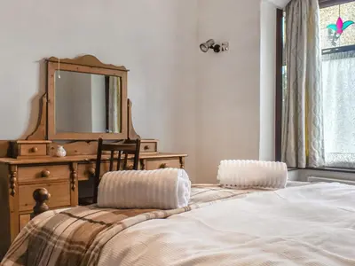 a bedroom with a bed and a dresser and a mirror at Melrose in Clitheroe