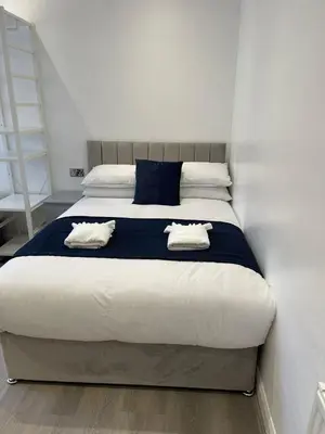 a bedroom with a bed with two pillows on it at Araan House Hotel -Families and Couples Only in Blackpool