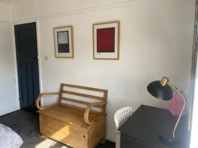 a room with a desk and a chair and a lamp at Lovely 2 Bed Full House By The Beach in Liverpool