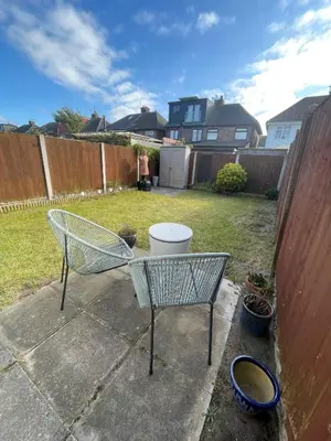 a chair in a yard next to a fence at Lovely 2 Bed Full House By The Beach in Liverpool