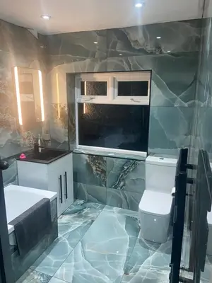 a bathroom with a sink and a toilet at Lovely 2 Bed Full House By The Beach in Liverpool