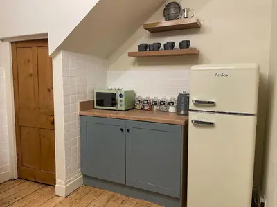 a kitchen with a white refrigerator and a microwave at The Riverside Tailor's Retreat at Wray in Wray