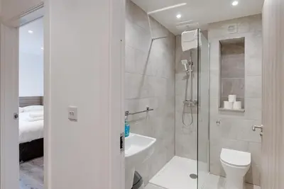 a bathroom with a shower and a toilet and a sink at Liverpool Short Stay Apartments in Liverpool