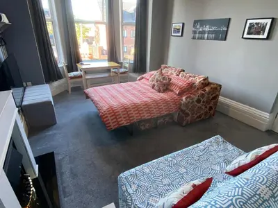 a living room with a couch and a chair at Well-appointed apartment in New Brighton in New Brighton
