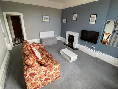 a living room with a couch and a television at Well-appointed apartment in New Brighton in New Brighton