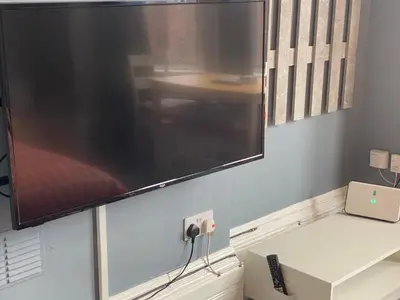 a flat screen tv hanging on a wall at Well-appointed apartment in New Brighton in New Brighton