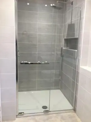 a shower with a glass door in a bathroom at ChurstonBnB, private flat within family home, Bolton in Lostock
