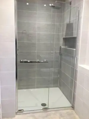 a shower with a glass door in a bathroom at ChurstonBnB, private flat within family home, Bolton in Lostock