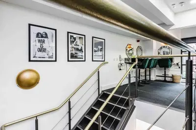 a staircase in a building with a gold railing at VIP city centre apartment with secure free parking in Liverpool