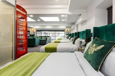 a hotel room with two beds and a couch at VIP city centre apartment with secure free parking in Liverpool