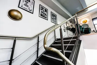 a staircase with a metal handrail in a house at VIP city centre apartment with secure free parking in Liverpool